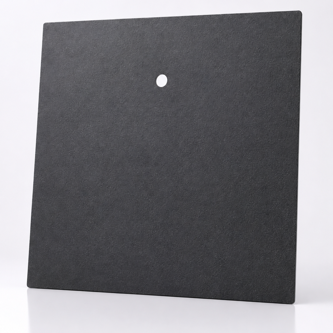 Black square tile with a central hole on a white background