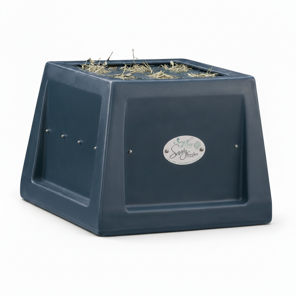 Dark plastic feeder with hay on a white background